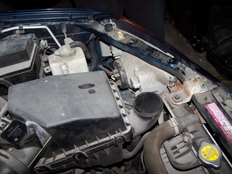 2000 Ford Crown Victoria - Engine bay components including air filter box, coolant reservoir, and radiator are visible.