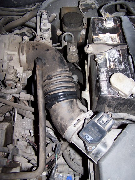 2000 Ford Crown Victoria - Close-up view of engine components including the air intake system and battery.