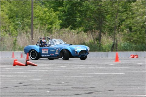 2001 Mercury Grand Marquis - A blue convertible race car navigates a course marked by orange cones.