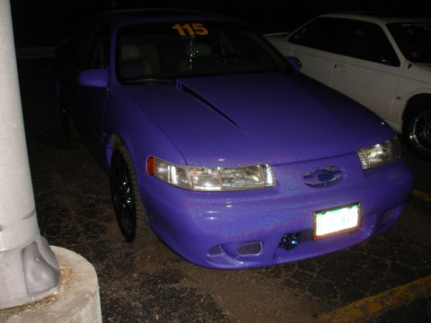 1993 Ford Taurus - Custom purple 1993 Ford Taurus with a racing number '115' on the windshield.