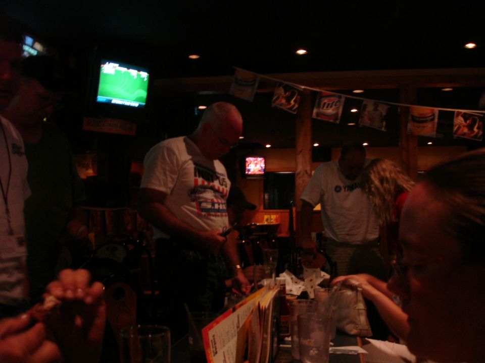 Interior of a bar with people and televisions