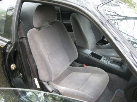 1995 Nissan 240SX - Interior view of a 1995 Nissan 240SX, highlighting the grey cloth seats and dashboard.