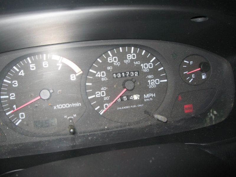 Car dashboard gauges showing 131,732 miles and tachometer reading