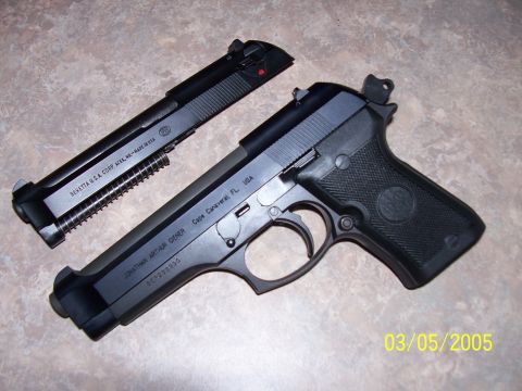 2000 Nissan Xterra - A Beretta pistol is shown disassembled, with the slide separated from the frame.