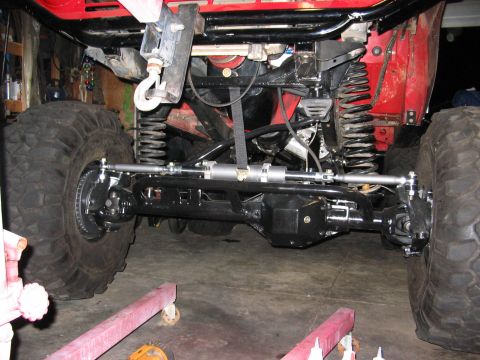 1970 Ford Bronco - Close-up view of the heavy-duty front suspension and steering system on a modified off-road vehicle.