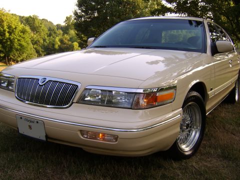 1996 Mercury Grand Marquis - A 1996 Mercury Grand Marquis is shown from the front three-quarter view, parked outdoors on a grassy area.