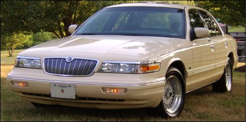 1996 Mercury Grand Marquis - Tan 1996 Mercury Grand Marquis sedan parked outdoors on grass.