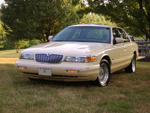 1996 Mercury Grand Marquis - A 1996 Mercury Grand Marquis is shown from the front three-quarter view, parked outdoors on a grassy lawn.