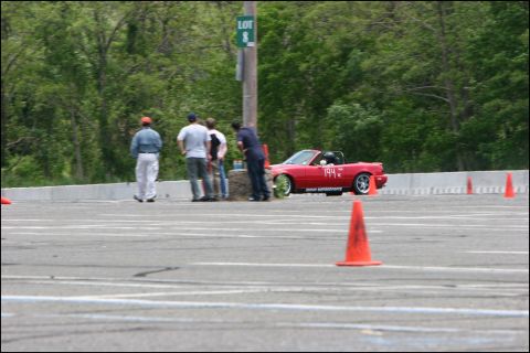 2001 Mercury Grand Marquis - A red convertible sports car with the number 194 on its door navigates a course marked by orange cones.