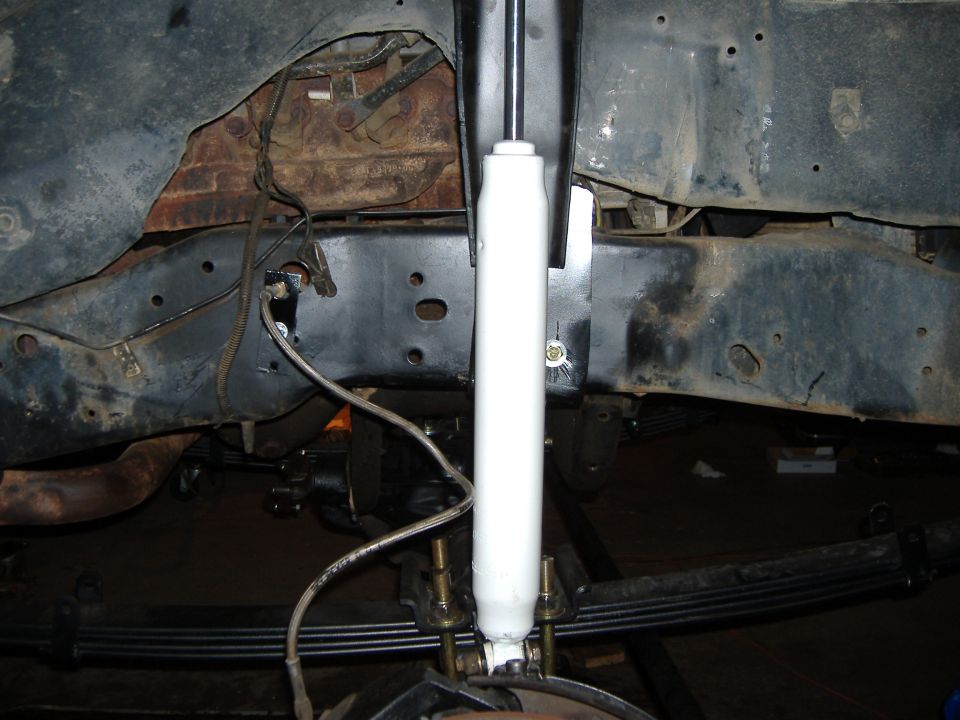 White shock absorber and leaf spring with new U-bolts under a Ford Bronco frame