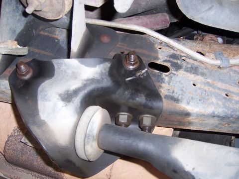 1991 Ford Bronco - Underside view of a vehicle's suspension system, focusing on a bracket and suspension arm.