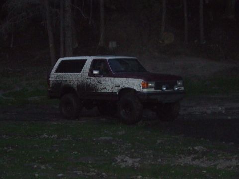 1990 Ford Bronco - Muddy 1990 Ford Bronco seen off-road at dusk.