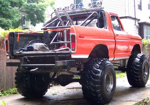 1978 Ford Bronco - This heavily modified pickup truck features oversized tires and a custom roll cage, with its bed removed.