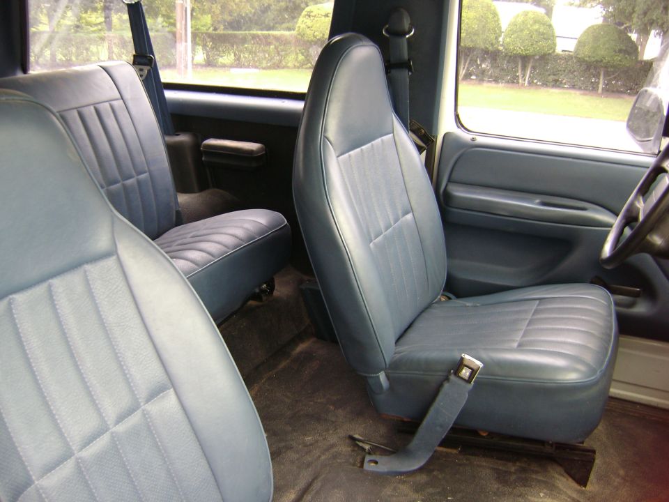 Blue cloth and vinyl front bucket seats inside a truck interior