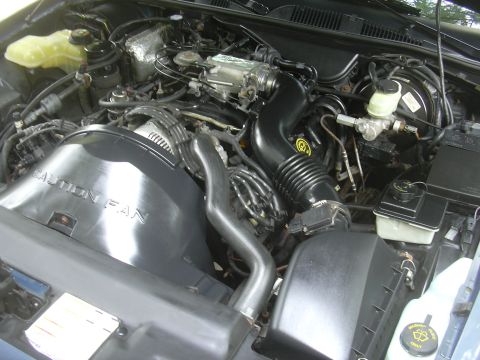 1996 Ford Crown Victoria - The engine compartment of a 1996 Ford Crown Victoria is shown, the air intake system and fan shroud.