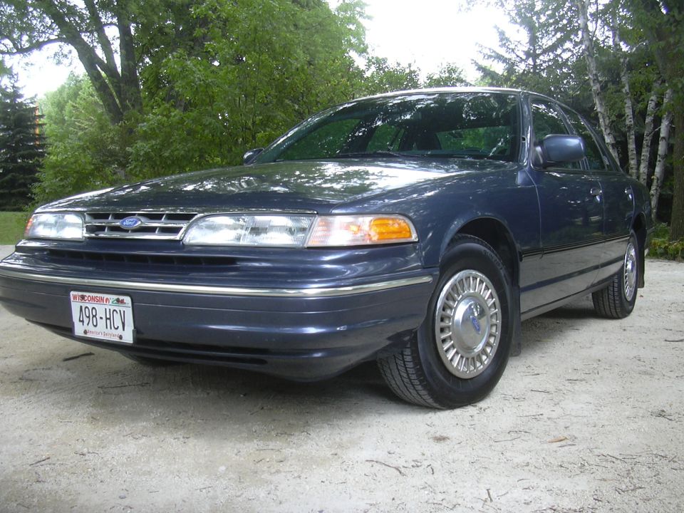 Dark blue sedan with chrome hubcaps and a Wisconsin license plate