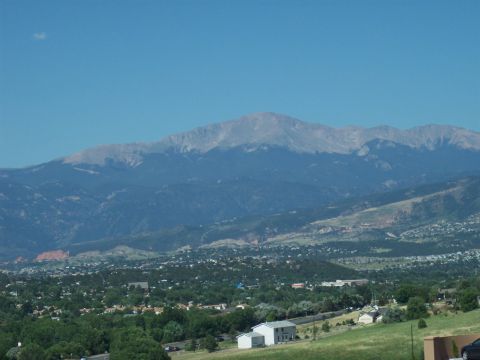 1972 Ford Ranchero - Panoramic view of a mountain range above a town and rolling green hills.