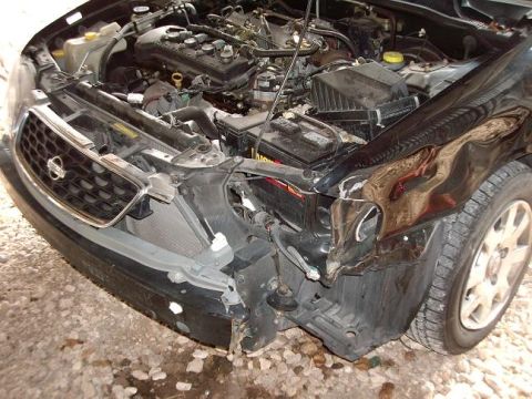 1996 Ford F-150 - Car with front-end damage, engine compartment exposed, radiator visible.