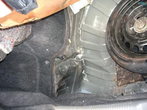 1996 Ford F-150 - Trunk spare tire well showing carpeted side panel and metal structure.