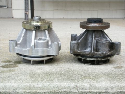 2001 Mercury Grand Marquis - A new water pump is compared to a used one, showing the difference in wear and tear.