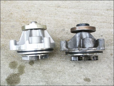 2001 Mercury Grand Marquis - Comparison of a new water pump with a used one, showing wear on the older part.
