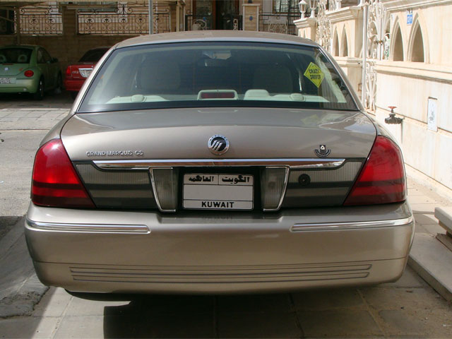 Rear view of a gold Mercury Grand Marquis GS sedan with a Kuwait license plate