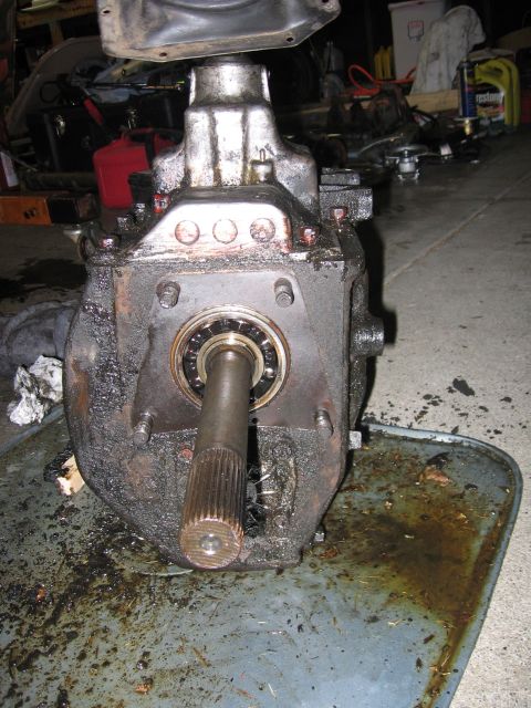 1989 Ford Bronco - A greasy transmission part, possibly from a donor truck, is shown with a splined shaft and bearing visible.