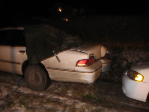 1992 Ford Crown Victoria - Rear view of a damaged 1992 Ford Crown Victoria, with another vehicle visible to the right.