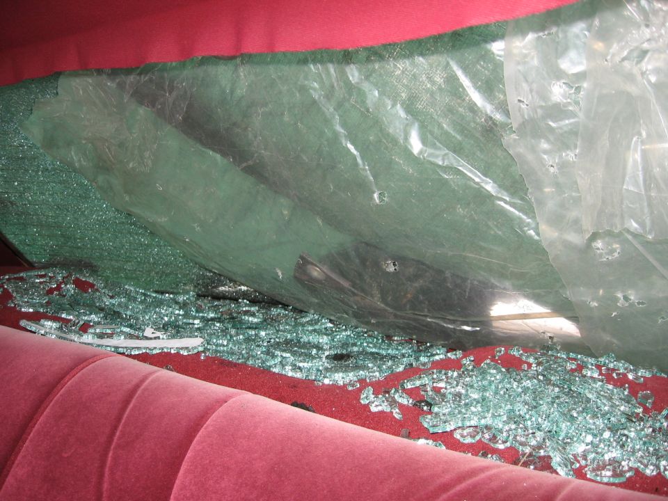 1992 Ford Crown Victoria interior with shattered rear window and red upholstery