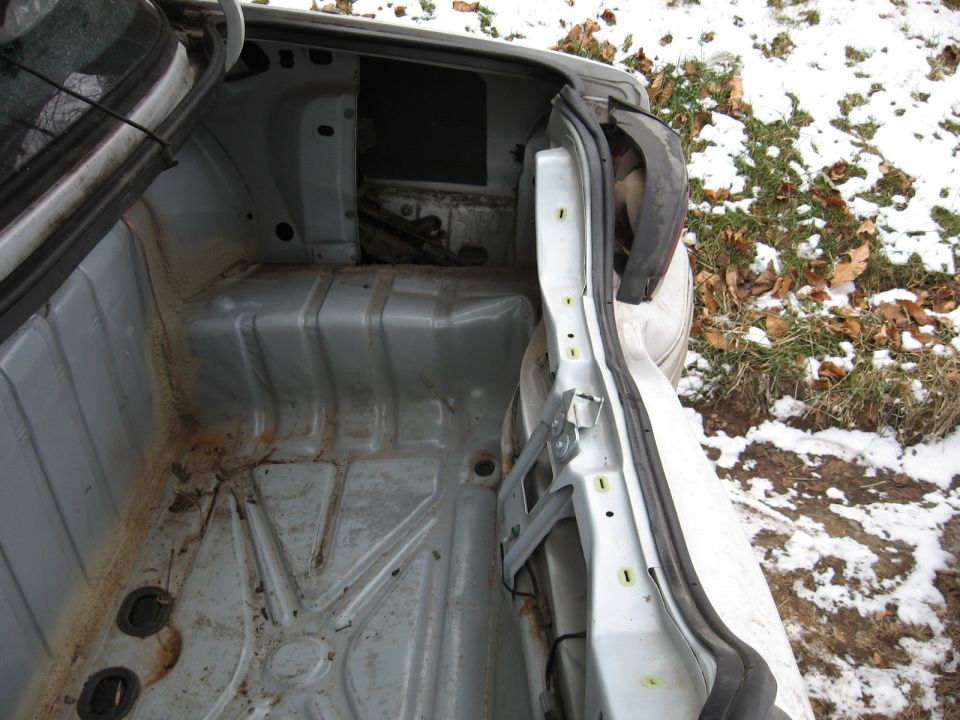empty car trunk, showing bare metal and some rust