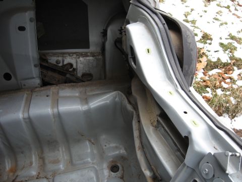 1992 Ford Crown Victoria - The interior of a car trunk shows damage and dirt, with a watermark indicating the source.