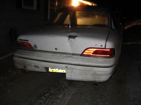 1992 Ford Crown Victoria - Rear view of a 1992 Ford Crown Victoria, note the damage to the trunk lid and the lit taillights.