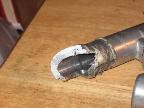 1992 Ford Crown Victoria - Close-up of a damaged metal pipe with a torn rubber seal, likely a vehicle part.