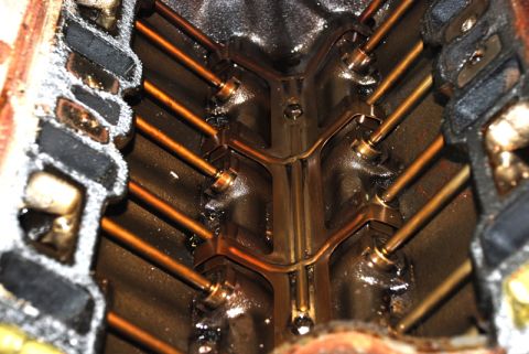 1996 Ford Bronco - Close-up view of an engine's intake manifold, showing the internal structure and pushrods.