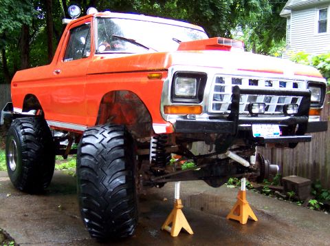 1978 Ford Bronco - This modified 1978 Ford Bronco is elevated on jack stands, revealing its suspension and large off-road tires.