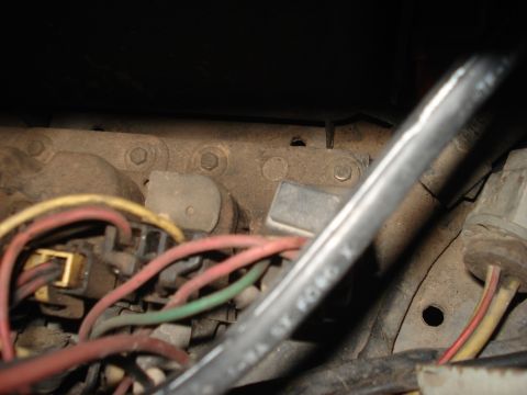 1986 Ford Bronco - Detail of a vehicle's electrical system, showing a wiring harness and relay with some text visible on a cable.