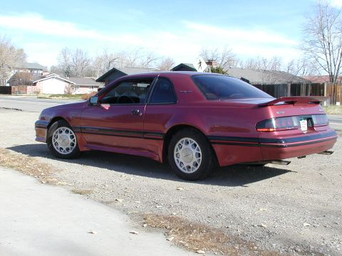 1987 Ford Thunderbird - Rear quarter view of a maroon 1987 Ford Thunderbird coupe with a spoiler.