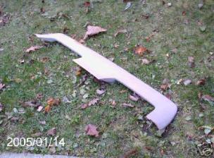 1987 Ford Thunderbird - A car body kit part is shown on the ground, with fallen leaves scattered around.