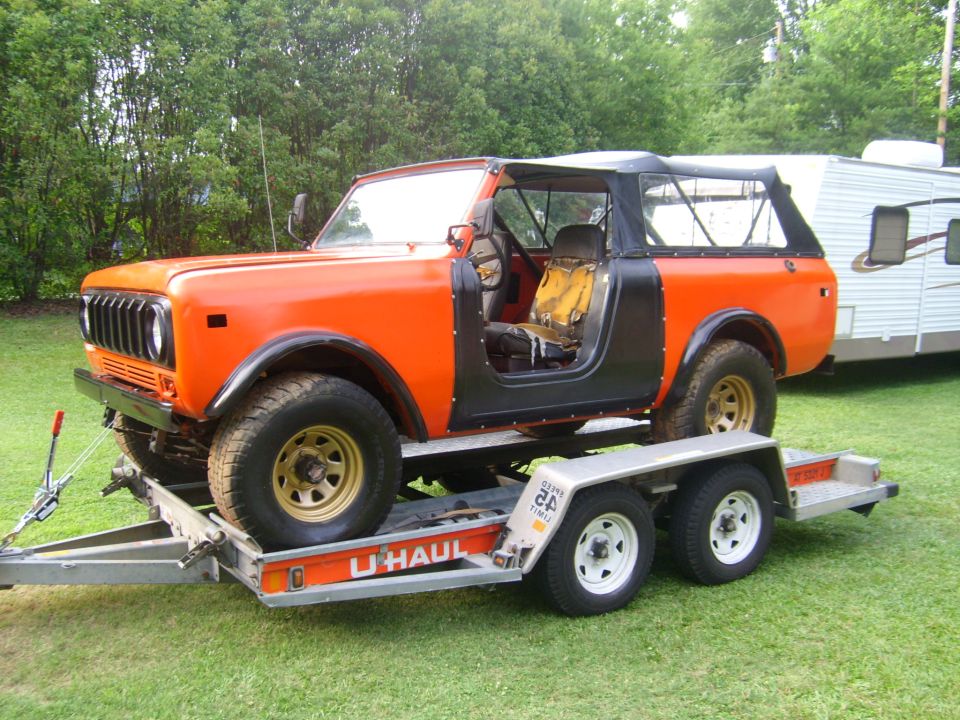Orange International Harvester Scout II on U-Haul trailer, soft top removed, doors off