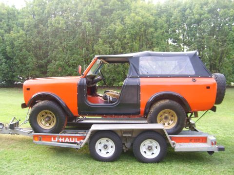 1994 Ford Bronco - This orange convertible SUV is being transported on a U-Haul trailer.