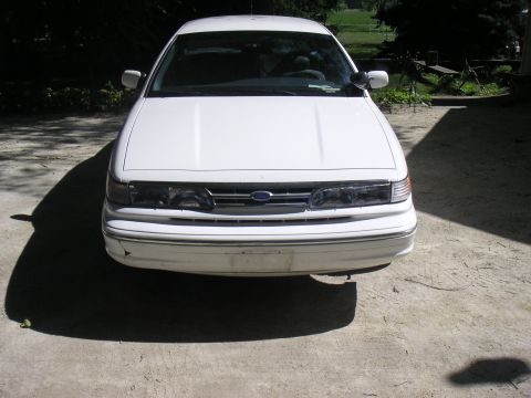 1997 Ford Crown Victoria - Front view of a white 1997 Ford Crown Victoria parked on a concrete surface.