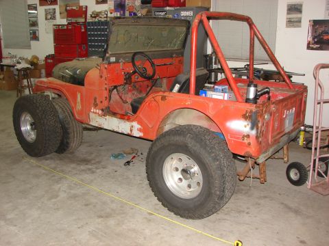 1978 Ford Bronco - This Jeep CJ5 appears to be undergoing some modifications or repairs in a workshop setting.