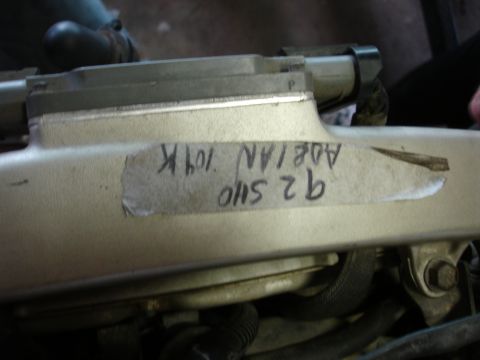 1993 Ford Taurus - A close-up view of an engine component with a handwritten label indicating '92 5410 ADEIAN 109K'.