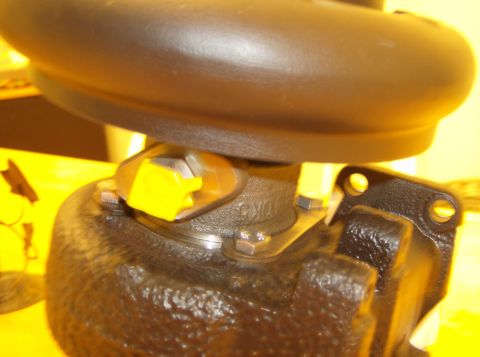1996 Ford Probe - A close-up view of a turbocharger component, yellow protective caps on its fittings.
