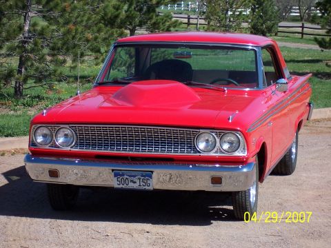 1994 Ford Bronco - This red 1963 Ford Falcon Futura features a prominent hood scoop and a classic front-end design.