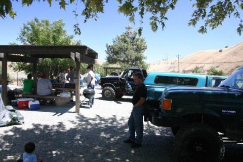 1989 Ford Bronco - A 1989 Ford Bronco is visible in the foreground at a meet and greet event.