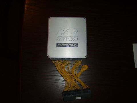 1991 Mazda RX-7 - An APEXi Power FC engine control unit is shown with its associated wiring harness.