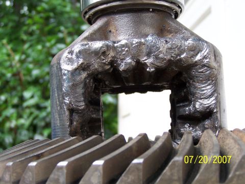 1979 Ford F-150 - Close-up of a heavily welded metal component, prominent gear teeth and a visible date stamp.