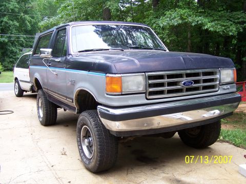 1979 Ford F-150 - Ford Bronco parked outside with a trailer hitched to the rear.