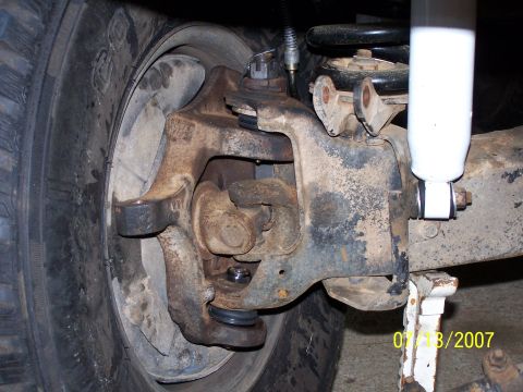 1979 Ford F-150 - Front suspension components are visible, including a tire, shock absorber, and steering knuckle.